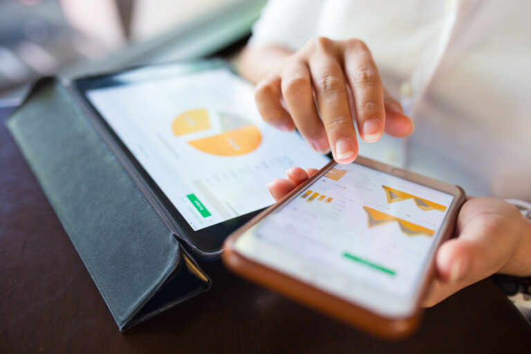 Businesswoman check data in smartphone and tablet